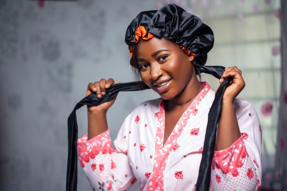 woman wearing satin bonnet