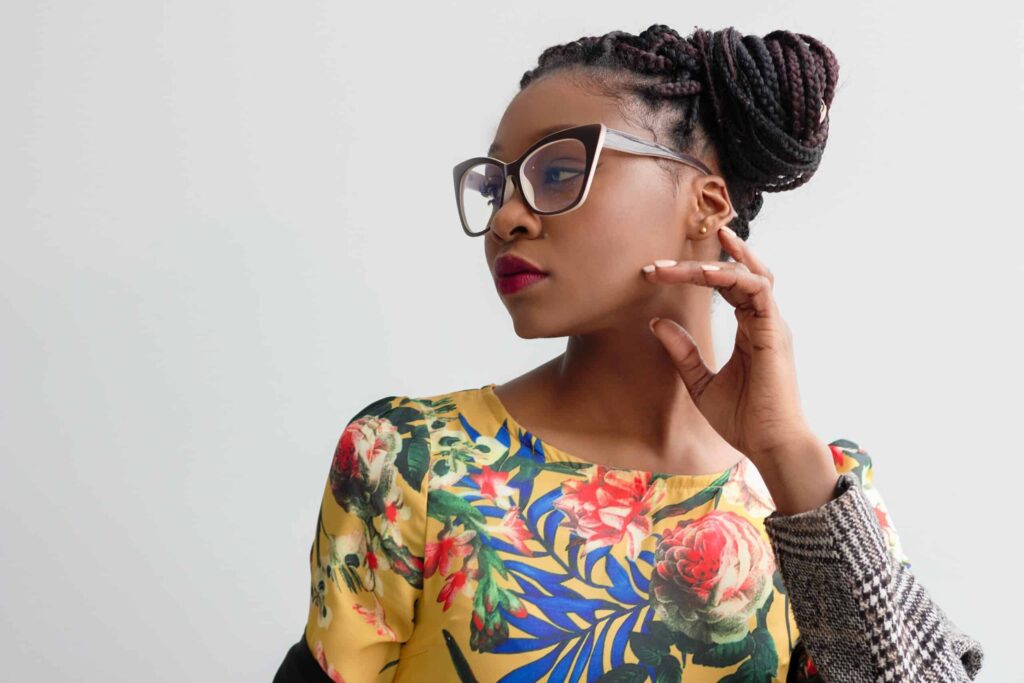 woman with big glasses and an up-do hairstyle