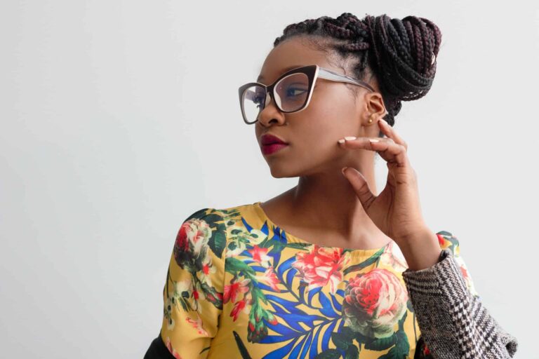 woman with big glasses and an up-do hairstyle